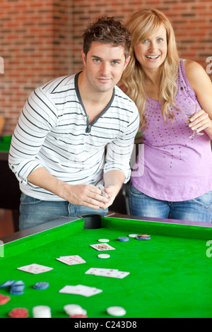 Couple playing cards on a billiard Stock Photo