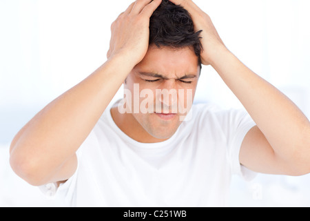 Man suffering from a migraine on waking Stock Photo