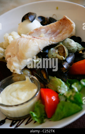 Traditional Provencal Aioli dish served with boiled fish and salad, Provence, France. Stock Photo