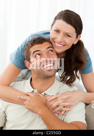 Portrait of beautiful woman hugging her husband from behind in park ...