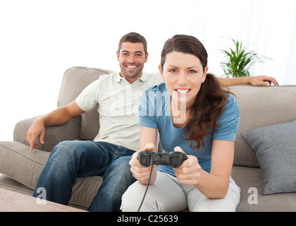 Concentrated woman playing video game with her boyfriend Stock Photo