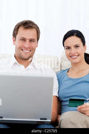Lovely couple buying onllne while relaxing on the sofa Stock Photo