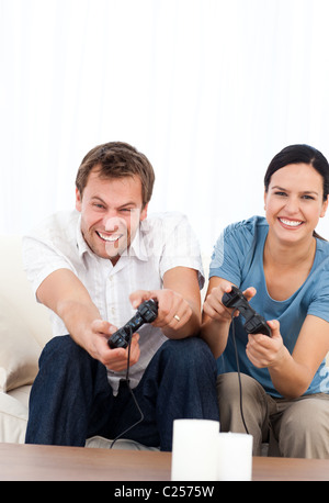 Excited man playing video games wth his girlfriend Stock Photo