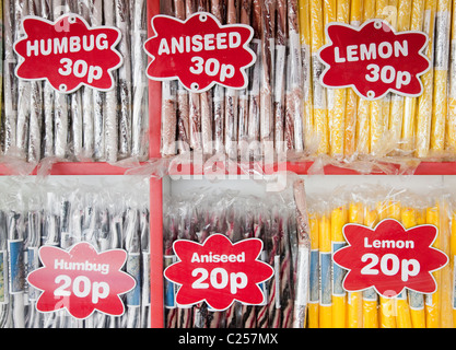 Colourful sticks of rock in a shop window on the esplanade at Filey, East Yorkshire Stock Photo