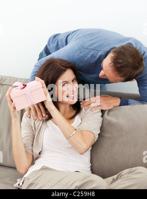 Happy woman trying to guess her present from her boyfriend Stock Photo
