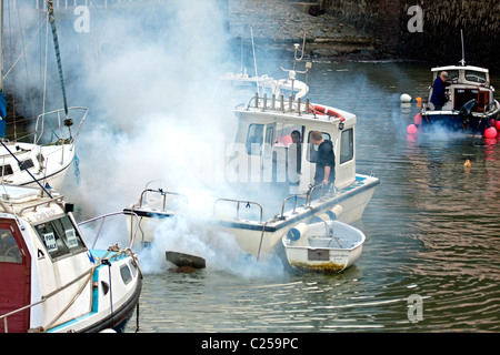 Boat with smoking engine in Lynmouth Harbour Stock Photo