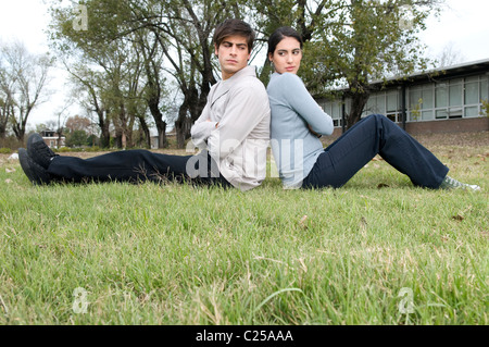 University students sitting on the field Stock Photo