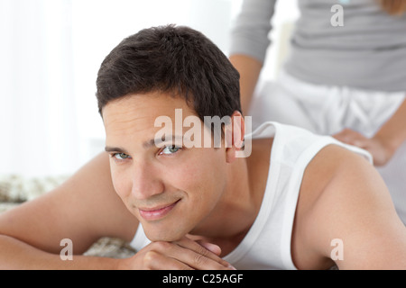 Portrait of a happy man being massaged by his girlfriend Stock Photo