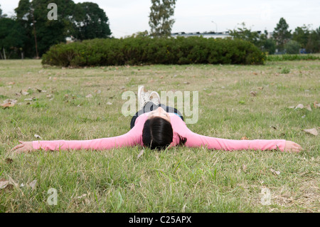 Female university student lying on campus Stock Photo