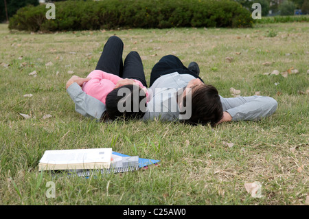 University students lying on campus Stock Photo