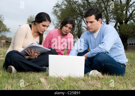 Students, at, campus, university, field, studying, pod, mp3, park, outdoors, sun, friends, having, fun. Stock Photo