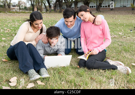 Students, at, campus, studying, mac, friends, university, uni, collage, exams, group, together, friends, sunshine, park, green. Stock Photo