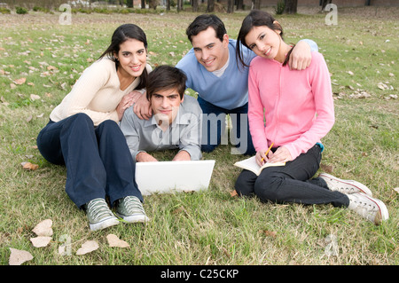 students, schoolmates, looking, at, the, camera, at, university, campus, studying, in, group, together, friends, uni, mac. Stock Photo