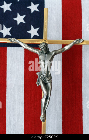 A Crucifix with an American flag in the background. This Crucifix lay on the casket of an American War Veteran. Stock Photo