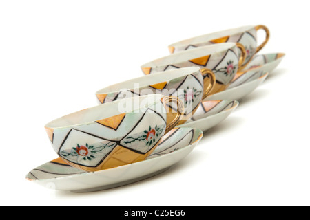 Vintage row of Japanese porcelain cups and saucers Stock Photo