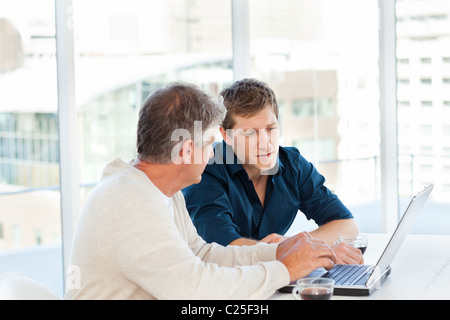 Two businessman working on their laptop Stock Photo