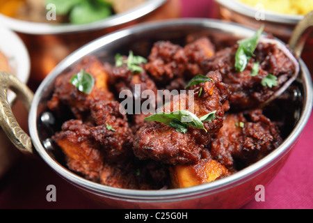 Authentic Kerala chicken fry garnished with curry leaves, a popular South Indian dish of chicken fried in a spicy coating. Stock Photo