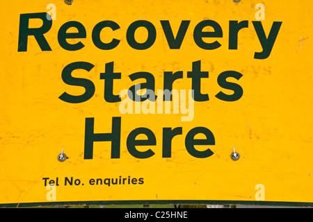 Recession and the recovery road sign.  Space to add a phone number. Stock Photo