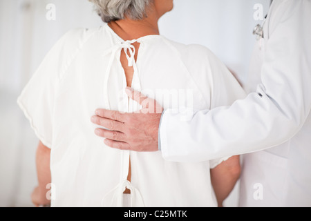 Doctor helping his patient to walk Stock Photo