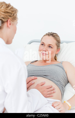 Nurse reassuring her pregnant patient Stock Photo