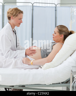 Nurse reassuring her pregnant patient Stock Photo