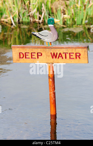 Deep Water Warning Sign in a Pond, Barrington, Cambridgeshire, England, UK Stock Photo