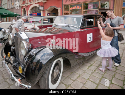 Man and daughter looking at 1948 Rolls-Royce Silver Wraith at Rolls-Royce & Bentley Club meeting in Świdnica, Silesia, Poland Stock Photo