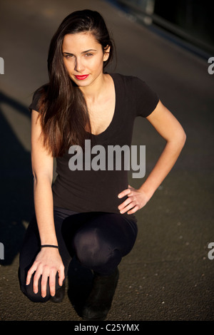Full length portrait of a beautiful woman on her knees, London, England, UK Stock Photo