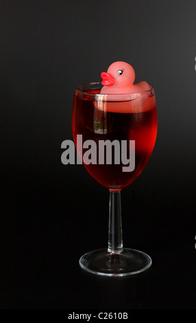 rubber duck in glass of rose wine Stock Photo