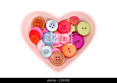 Buttons in plate of heart shape Stock Photo