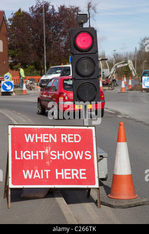 Red temporary traffic lights at road works. Stock Photo
