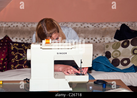 Woman Using Sewing Machine Stock Photo