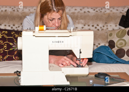 Woman Using Sewing Machine Stock Photo
