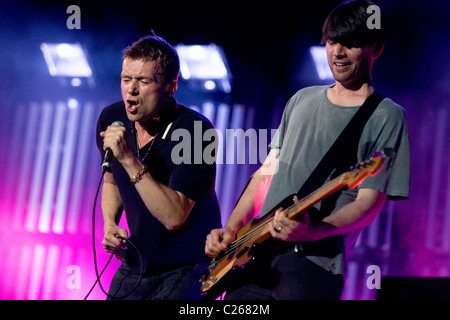 Singer and front man Damon Albarn and bassist Alex James from British indie rock band Blur play Glastonbury Festival. Stock Photo