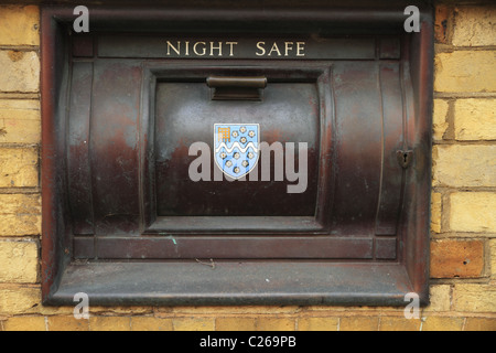 An old night safe on the external wall of a bank in Arundel, West Sussex, England. Stock Photo