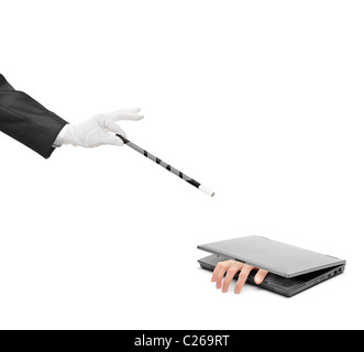 A hand reaching out from a laptop and hand holding a magic wand Stock Photo