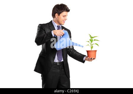 Portrait of a businessman holding a flower and watering can Stock Photo