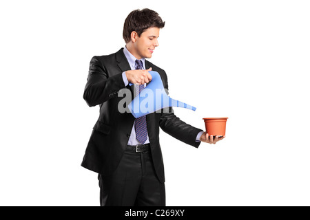 Portrait of a businessman holding an empty flower pot and watering can Stock Photo
