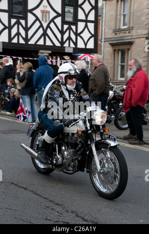 Motorcyclist on his beautifully prepared Royal Enfield Motorbike rides through Wootton Bassett taking part in the Charity Ride o Stock Photo