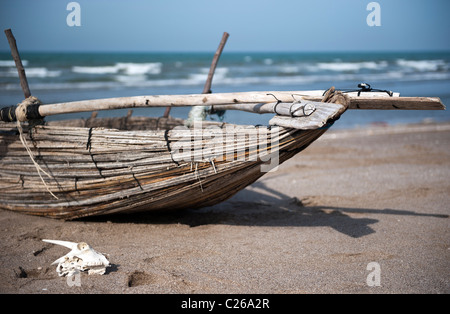 Traditional Omani fishing boat on the beach near Muscat Stock Photo