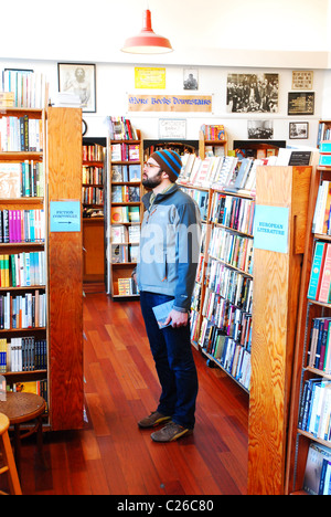 A customer browses the shelves of City Lights Book Store in San Francisco. Stock Photo