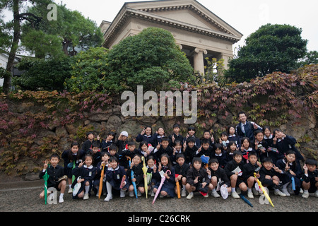 Group of school children and their teacher posing in front of Ohara Museum of Art, Bikan historical district, Kurashiki, Japan. Stock Photo
