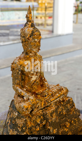Seated Buddha Statue Covered in Gold Leaf at the Grand Palace in Bangkok, Thailand Stock Photo