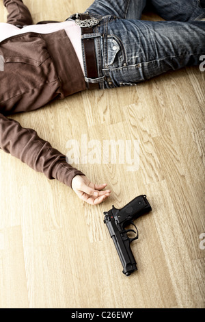 crime scene, dead body on floor and pistol Stock Photo