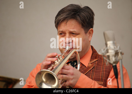 Musician from the old time band Funny Fellows playing on the jazz trumpet. Stock Photo