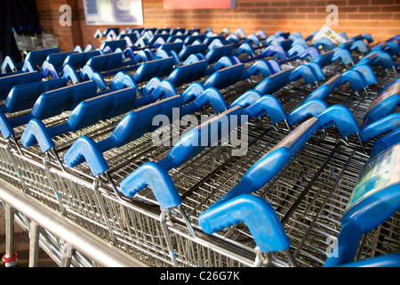 Supermarket parked shopping trolleys Salisbury England UK Stock Photo