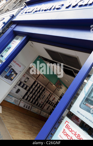 THE CARPHONE WAREHOUSE, emphasis and main focus on the mobile phone display inside the store, viewed at an angled aspect. Stock Photo