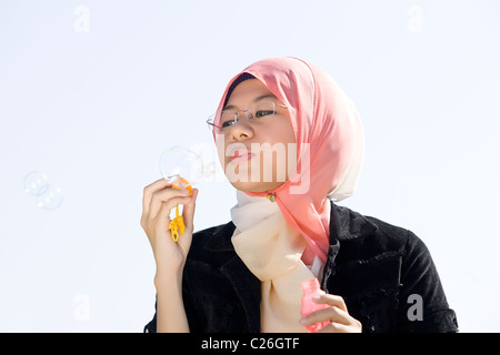 Young muslim girl play with soap bubble Stock Photo