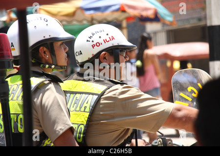 One policewoman and one policeman, in uniform, riding a motorcycle Stock Photo