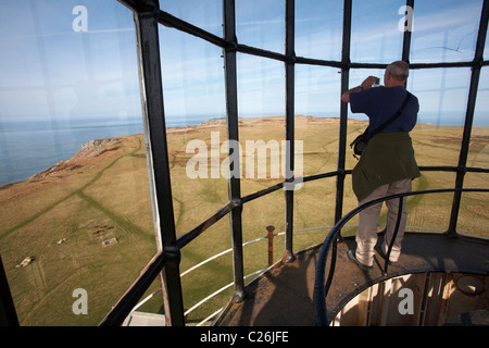 Taking photos at the top of Old Light House lighthouse of the views below on Lundy Island, Devon, England UK in March Stock Photo